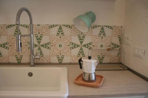 a kitchen counter with a sink and a blender at Casa Ninetta, tra mare e natura. in Finale Ligure