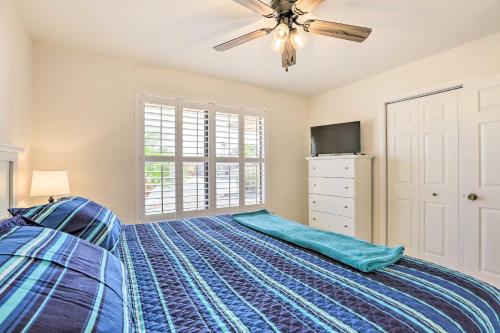 a bedroom with a bed and a ceiling fan at Less Than 1 Mi to Golf Home with Screened Porch in Sun City in Sun City West