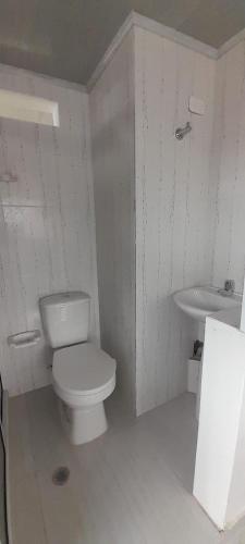 a bathroom with a white toilet and a sink at Casa ElVIAJERO Tipo HOSTAL in Popayan