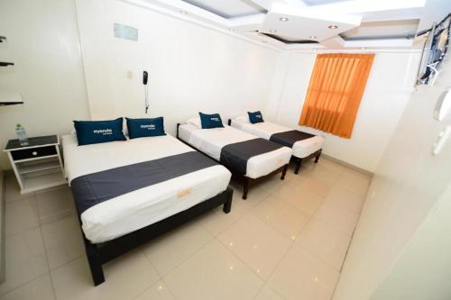 Un pat sau paturi într-o cameră la Hotel Kalu