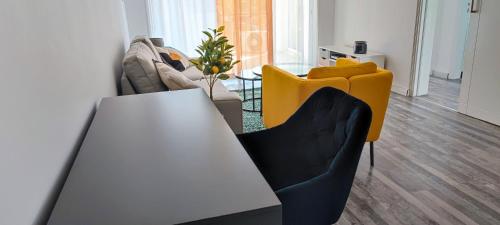a living room with a white table and yellow chairs at Zinas modern flat Nicosia in Strovolos