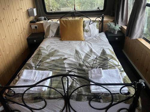 a bed in the back of a rv at Bus and the lodge With space and views in Bladon