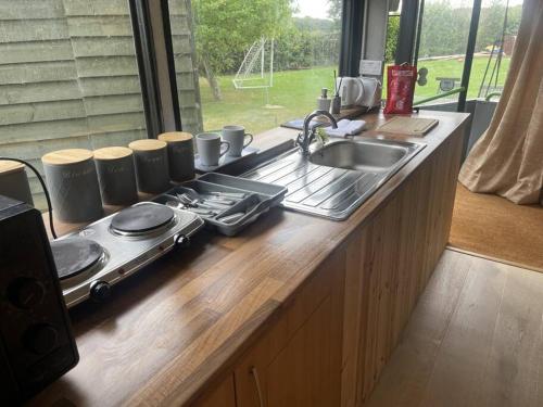 a kitchen counter top with a sink and a sink at Bus and the lodge With space and views in Bladon