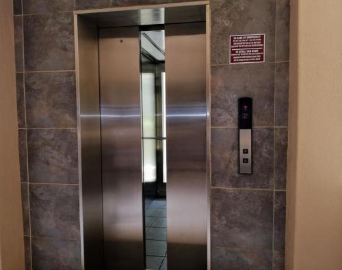 an elevator in a building with a sign on the wall at Santorini Unit RR in Margate