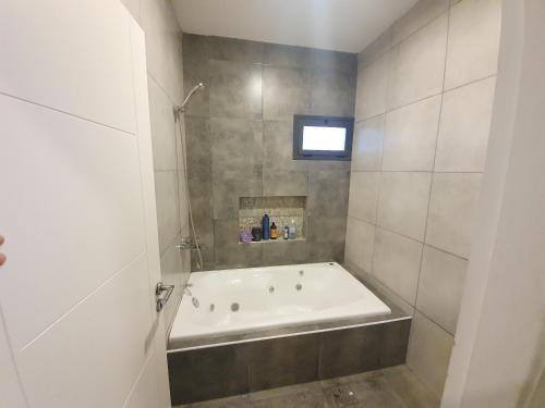 a bathroom with a bath tub in a room at Casa al Pie de los Andes in Ciudad Lujan de Cuyo