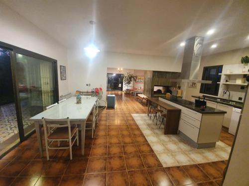 a kitchen and dining room with a table and chairs at Casa al Pie de los Andes in Ciudad Lujan de Cuyo