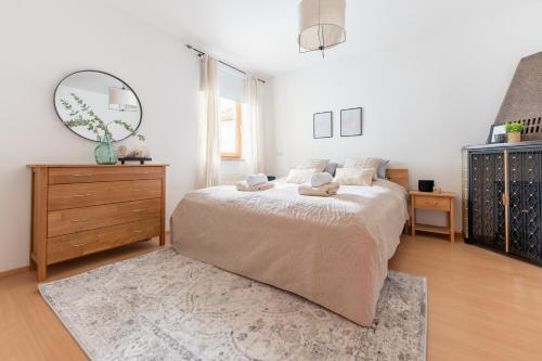 Schlafzimmer mit einem Bett, einer Kommode und einem Spiegel in der Unterkunft Villa Venus in Willendorf in der Wachau
