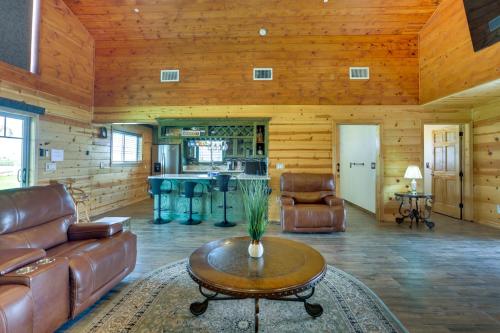 a living room with leather furniture and a table at Rustic California Vacation Rental with Rooftop Patio in Tulare