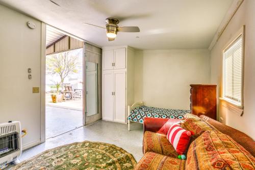 a living room with a bed and a couch at Rustic California Vacation Rental with Rooftop Patio in Tulare