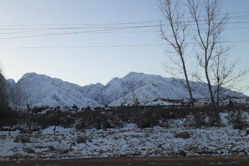 a snow covered field with mountains in the background at Vista los Andes in Cacheuta