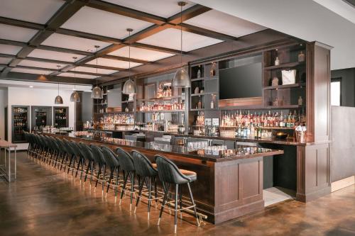 a bar with a row of bar stools at Residence Inn by Marriott Big Sky/The Wilson Hotel in Big Sky
