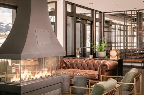 a living room with a couch and a fireplace at Residence Inn by Marriott Big Sky/The Wilson Hotel in Big Sky