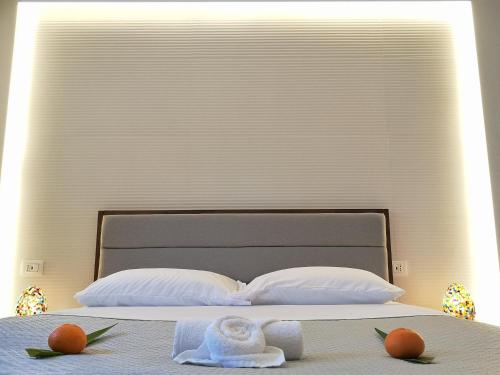 a bed with two towels and two oranges on it at Panorama Suite in Piazza Armerina