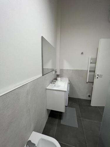 a bathroom with a sink and a toilet and a mirror at CasaCalzolari FIERA METEO TECNOPOLO BO in Bologna