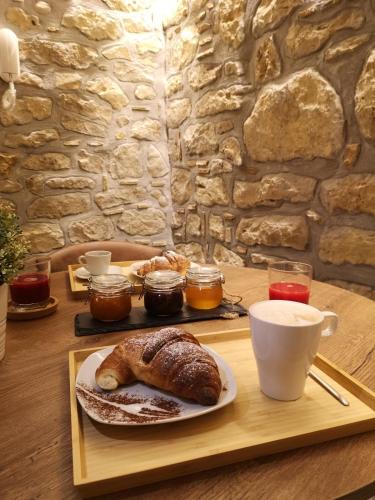 a table with a plate of bread and a cup of coffee at Panorama Suite in Piazza Armerina