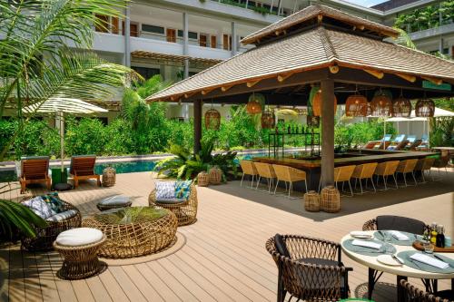 a patio with a gazebo and tables and chairs at laïla, Seychelles, a Tribute Portfolio Resort in Mahe