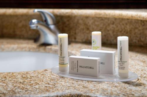 a bathroom counter with three candles on a sink at Courtyard by Marriott Wichita Falls in Wichita Falls