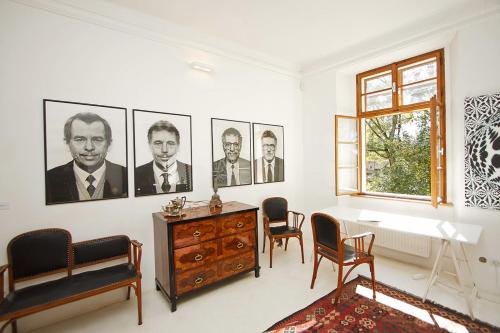 a living room with pictures of men on the wall at Chateau Třebešice in Kutná Hora
