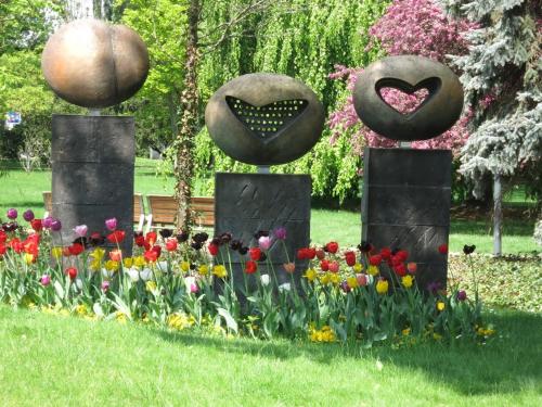 two stone monuments with flowers in a park at Homestay Poděbrady in Poděbrady