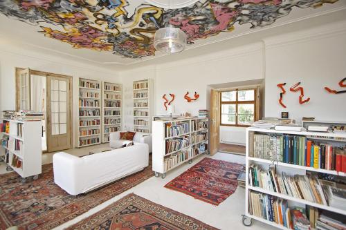 a living room with a couch and bookshelves at Chateau Třebešice in Kutná Hora