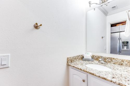 La salle de bains est pourvue d'un lavabo et d'un miroir. dans l'établissement Sunset Harbor Palms 2-304, à Navarre