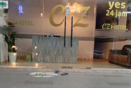 a window of a store with a parking meter on it at CZ HOTEL in Pasir Puteh