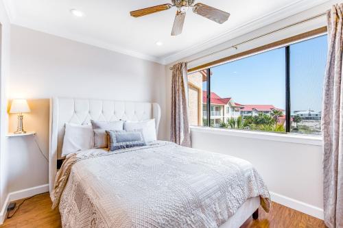 a bedroom with a bed and a large window at Sunset Harbor Palms 2-304 in Navarre