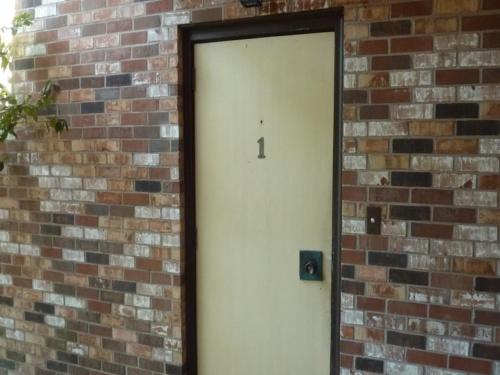 a door in a brick wall with the number one on it at Atlantic Breeze by Jekyll Realty in Jekyll Island