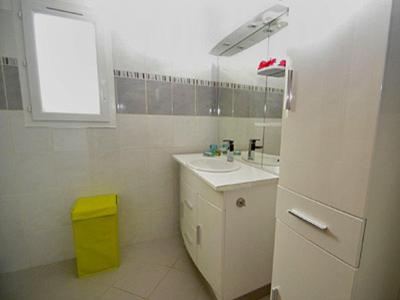 La salle de bains blanche est pourvue d'un évier et d'un réfrigérateur. dans l'établissement Holiday Home Serena, à Cervione