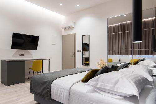 a bedroom with a large bed and a desk at Seascape Luxury Rooms in Split