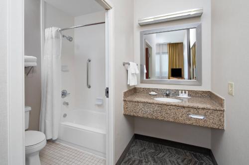 a bathroom with a sink and a shower and a toilet at SpringHill Suites by Marriott Chicago O'Hare in Rosemont