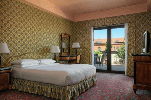 a bedroom with a large bed and a large window at Milan Marriott Hotel in Milan