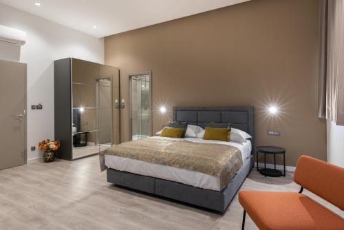 a bedroom with a large bed and two chairs at Seascape Luxury Rooms in Split