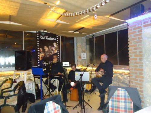 a group of people sitting in a room with instruments at Bells Motel in Seferihisar