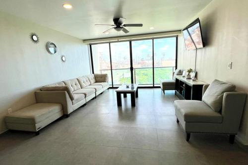 a large living room with couches and a ceiling fan at Luxury 2BR Condo Rosarito (D) in Rosarito