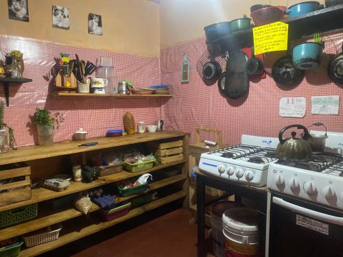 a kitchen with a stove and some pots and pans at Casa de los colores San cris in San Cristóbal de Las Casas