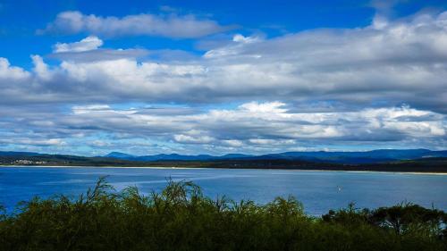 a view of a large body of water with clouds at Bantry Two in Merimbula