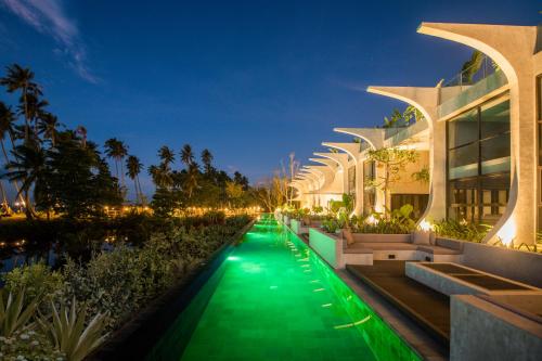 a building with a green walkway at night at The Hotel Elizabeth Resort and Villas - Long Beach San Vicente Palawan in San Vicente
