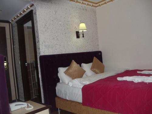 a hotel room with a bed and a mirror at Ares Hotel in Istanbul