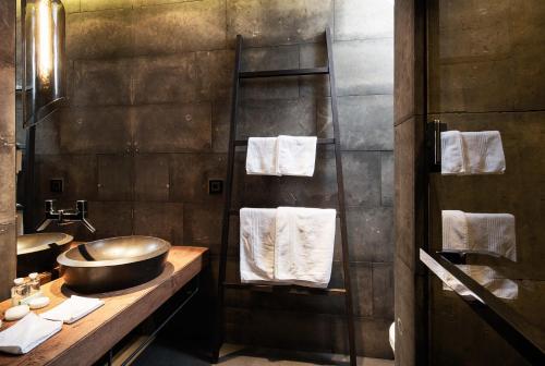 a bathroom with a sink and a counter with towels at Chalet Residences Mathon in Ischgl