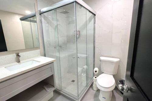 a bathroom with a shower and a toilet and a sink at Luxury 2BR Condo (F) Rosarito in Rosarito