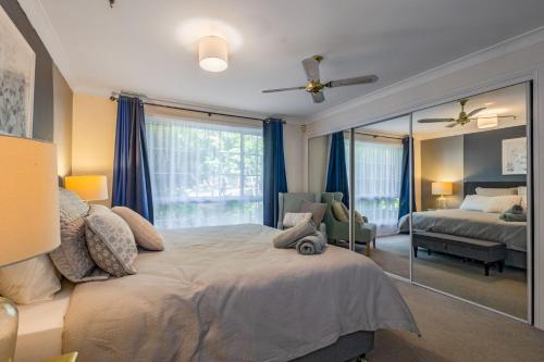 a bedroom with a large bed and a mirror at Swanbrook in Mount Victoria
