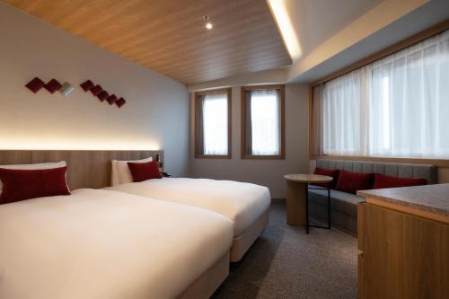 a hotel room with two beds and a bar at Hotel JAL City Haneda Tokyo in Tokyo