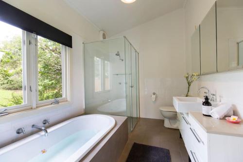 a bathroom with a tub and a toilet and a window at Nowra Beauty in Nowra