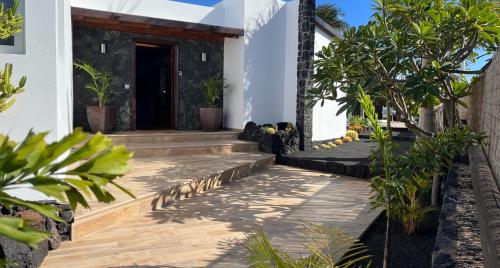 a house with a staircase leading to the front door at Casa Chic Lanzarote in Puerto del Carmen