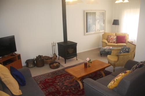 a living room with a couch and a wood stove at Oaklands in Little Hartley