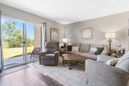 a living room with a couch and chairs and a table at Spruce Valley in Branson