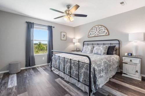 a bedroom with a bed and a ceiling fan at Spruce Valley in Branson