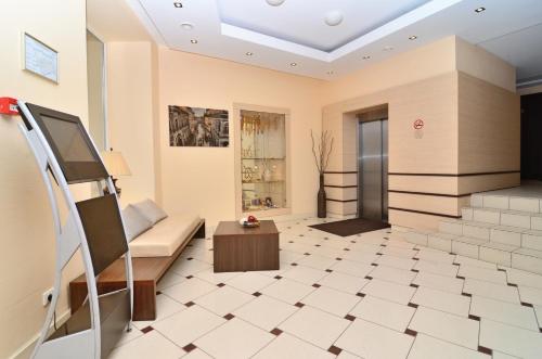 a living room with a couch and a table at Ivolita Vilnius in Vilnius