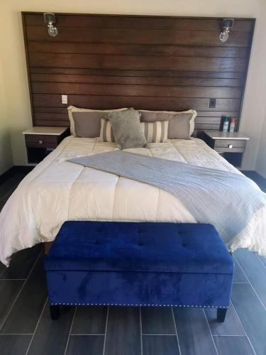 a bedroom with a large bed with a wooden headboard at Omni Sancti Hotel Boutique & Polo Club in Francisco Zarco